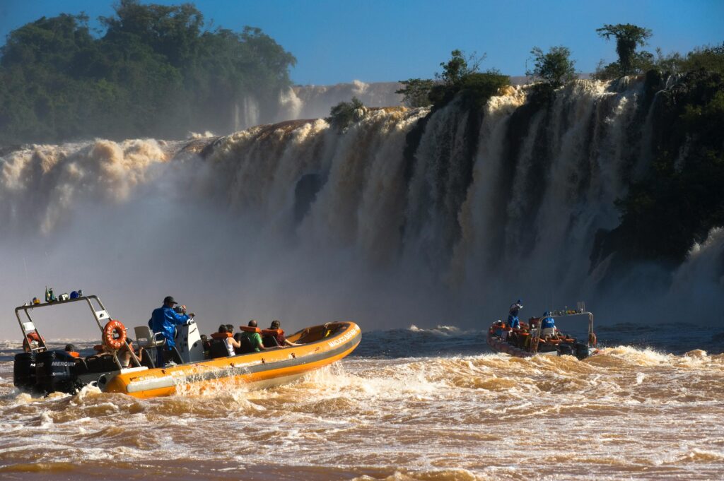Thrilling boat ride in front de the majestic Iguazu Falls, capturing the adventure and natural beauty.