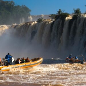 Thrilling boat ride in front de the majestic Iguazu Falls, capturing the adventure and natural beauty.